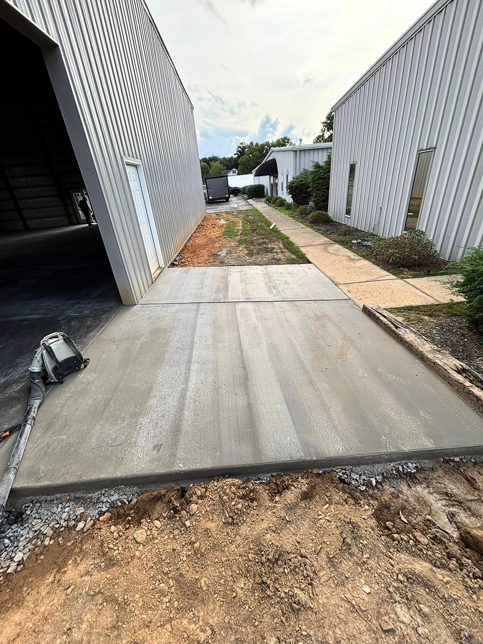 Finished concrete apron connecting two metal buildings