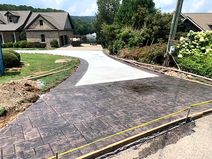 Residential concrete driveway with a decorative stamped entry and curved approach