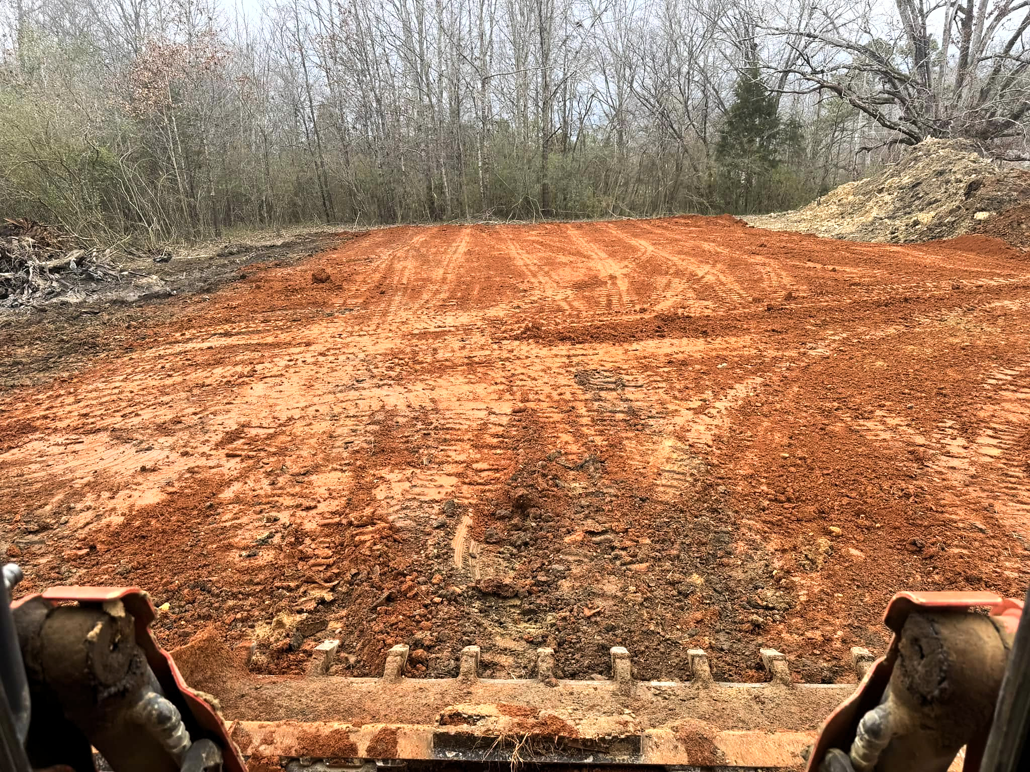 Graded red clay building pad prepared for construction